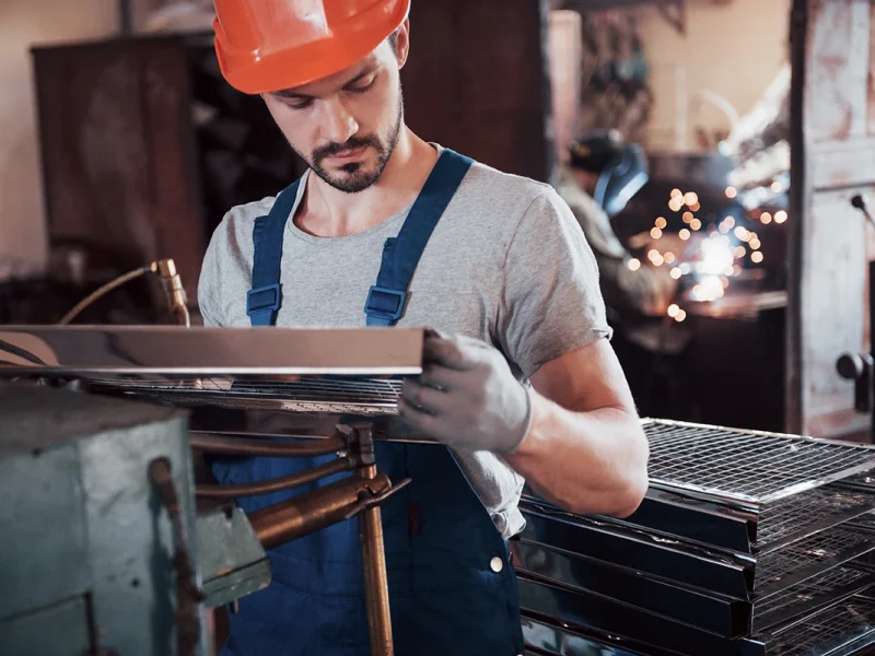 portrait-of-a-young-worker-in-a-hard-hat-at-a-larg-2023-11-27-05-20-22-utc